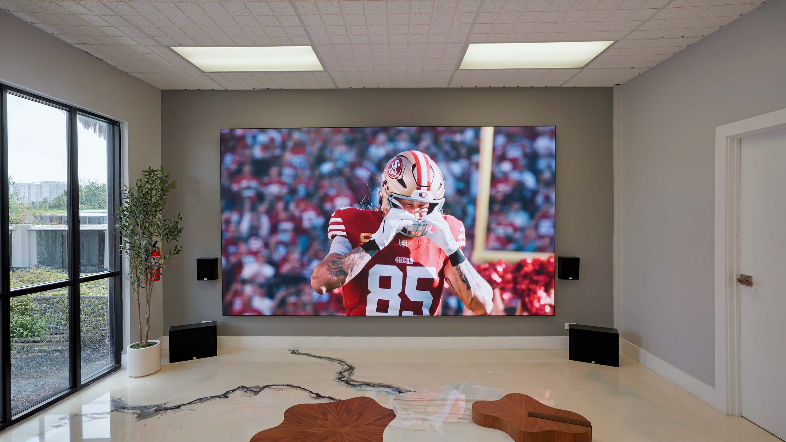 Lunar Walls MicroLED wall displaying football in a bright modern media room